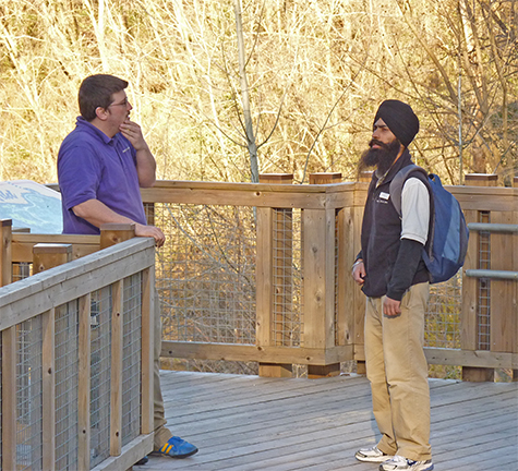 Boggs and Gurlal (Guest relations) discuss something (obviously important) at the top of the boardwalk leading to Explore the Wild. 